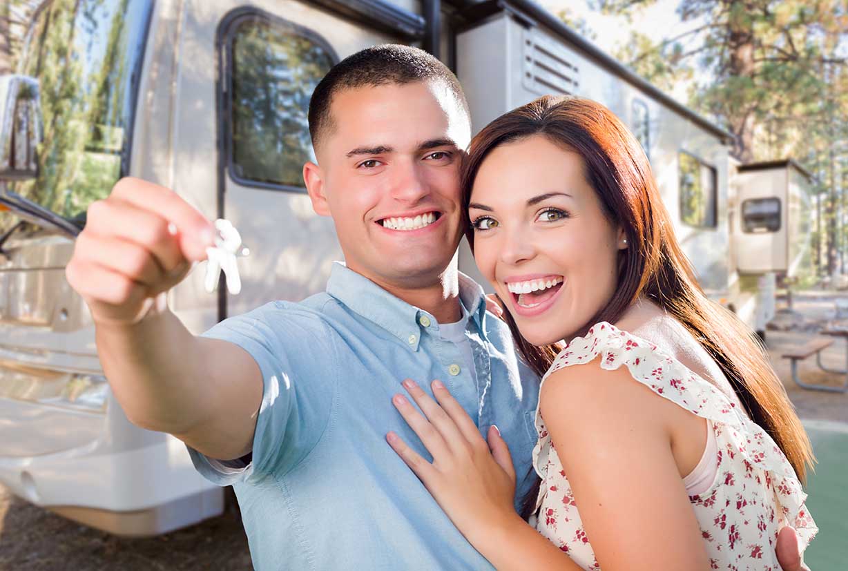 Young Military Couple Holding In Front of New RV